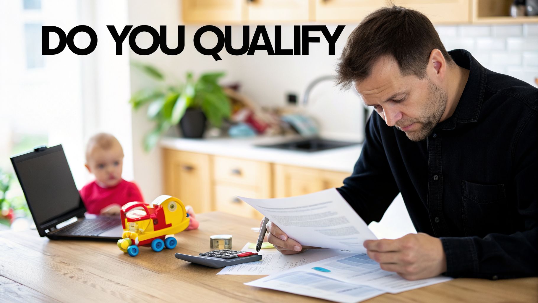 Man reviewing documents and a calculator at a table, with a baby visible in the background.