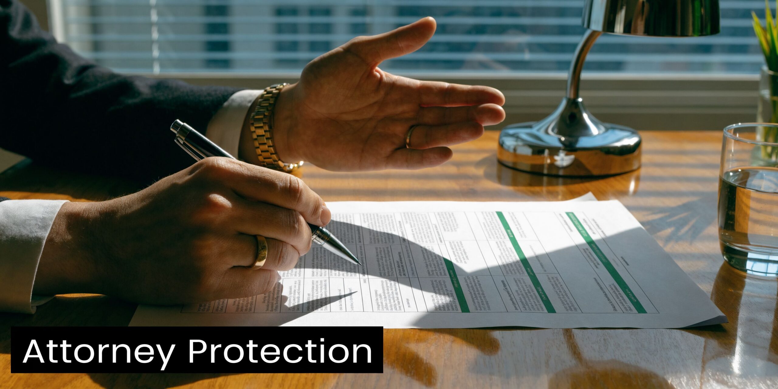 A professional attorney gesture while pointing at a legal document on a wooden office desk.