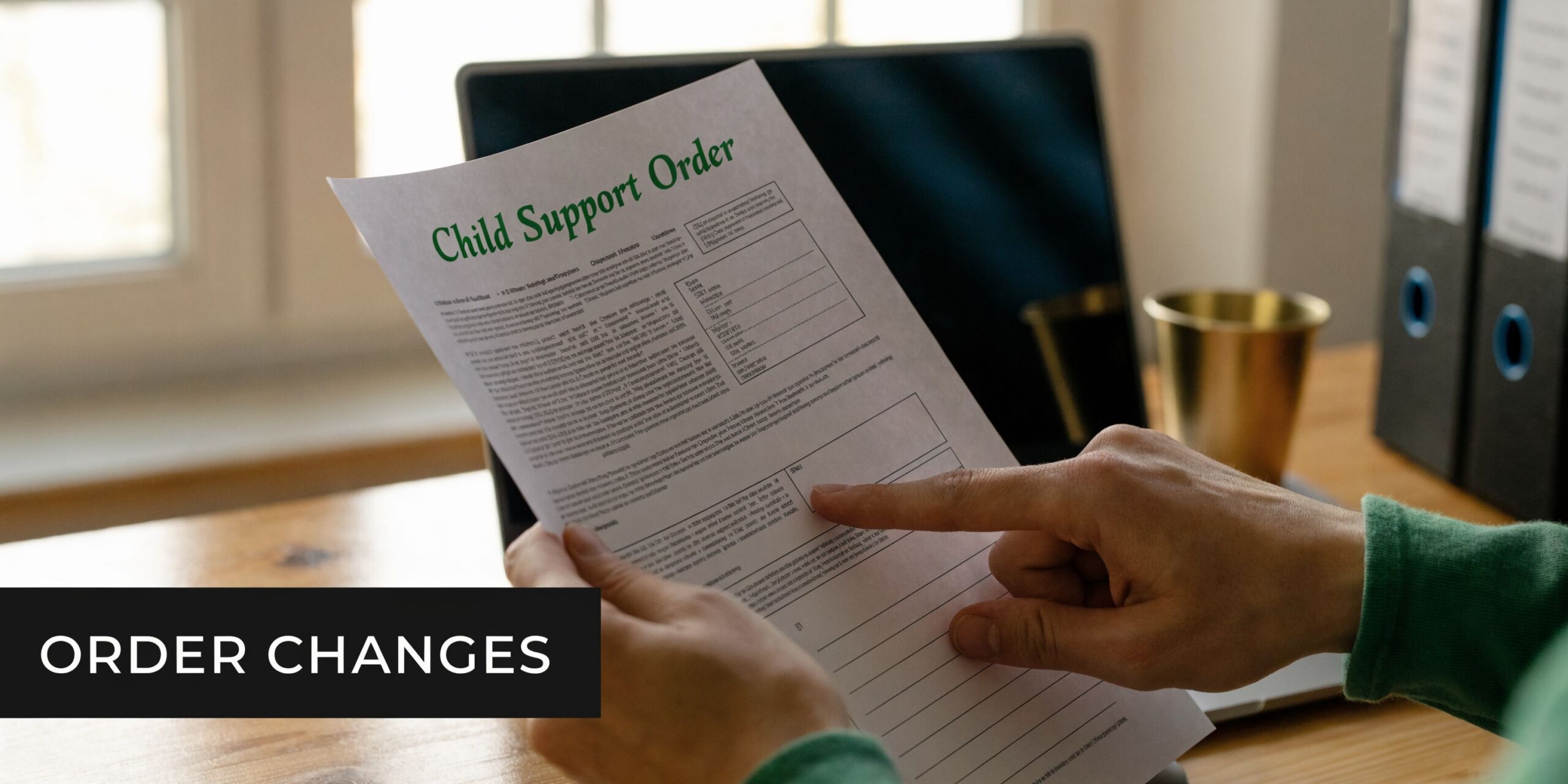 A person reviewing a Child Support Order document, highlighting the importance of legal assistance in family law.
