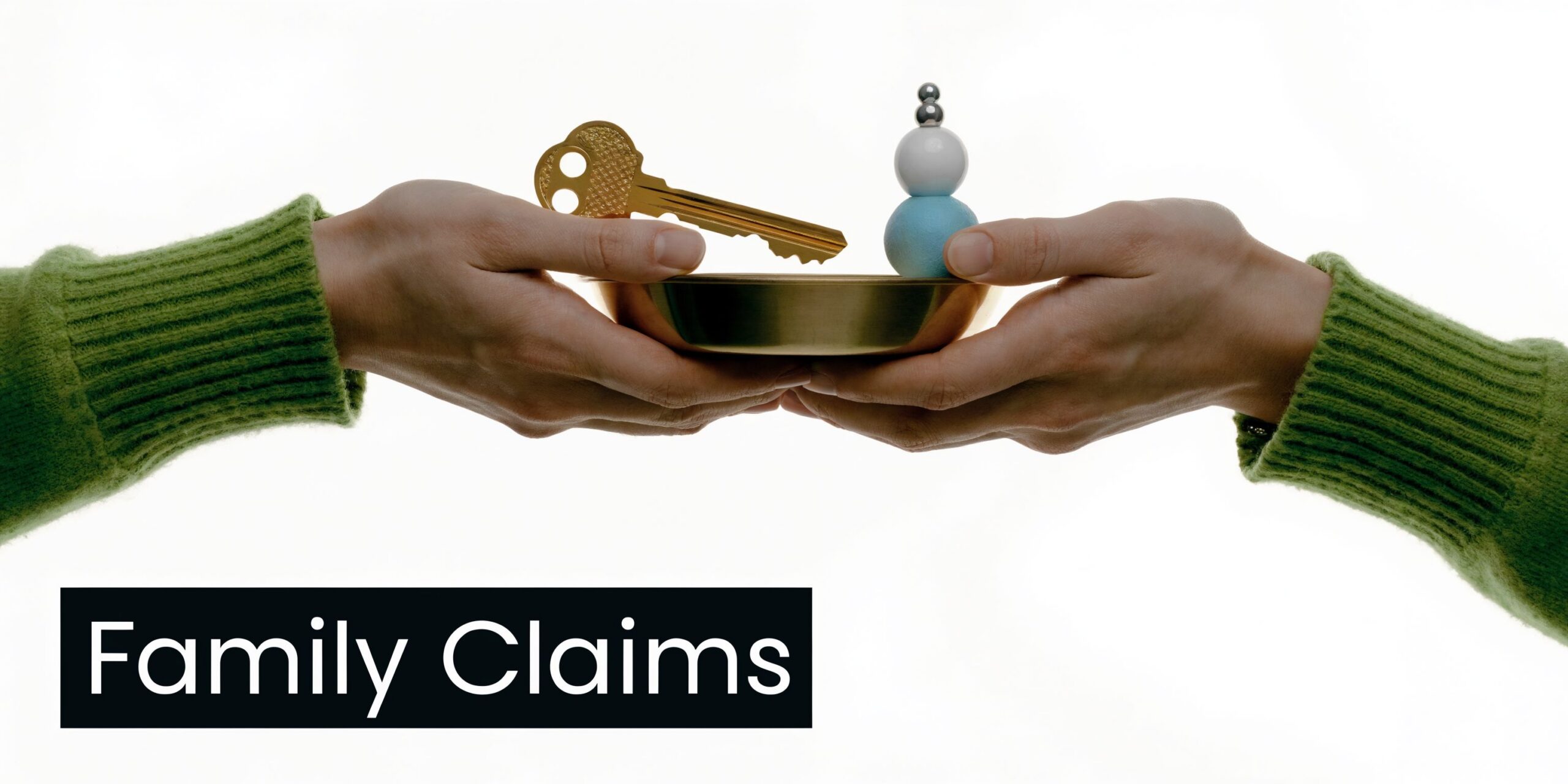 Two people holding a golden bowl containing a key and a stack of small decorative spheres.