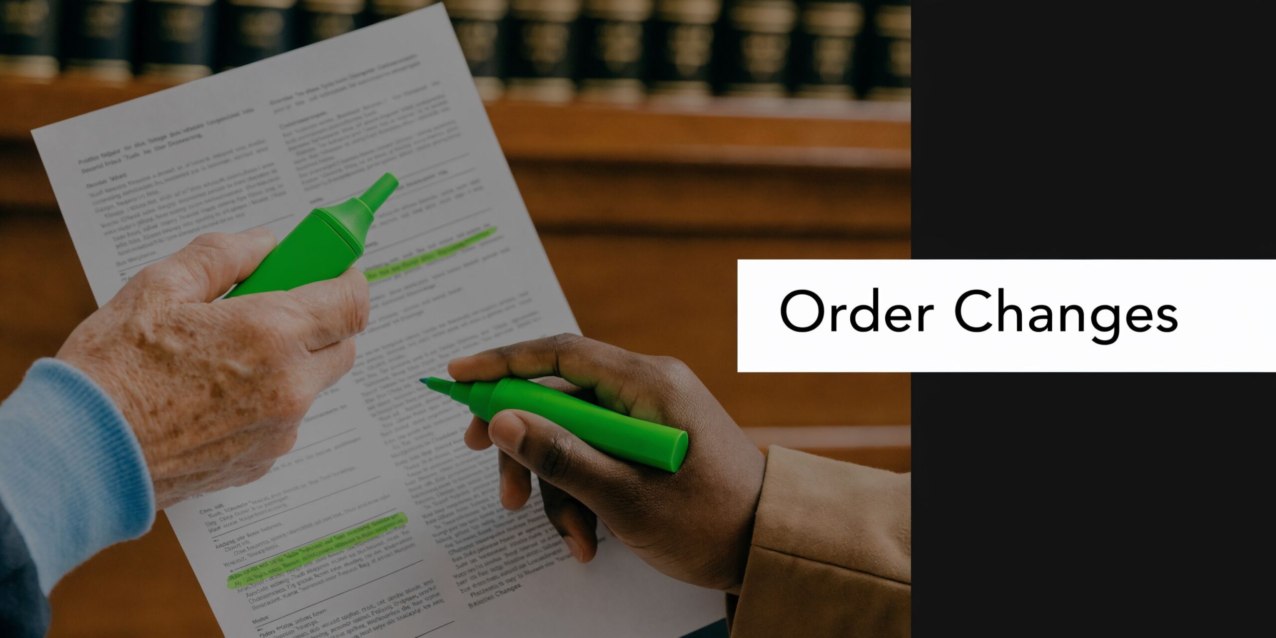 Two people highlighting legal documents in a law library, representing legal assistance for child support issues.