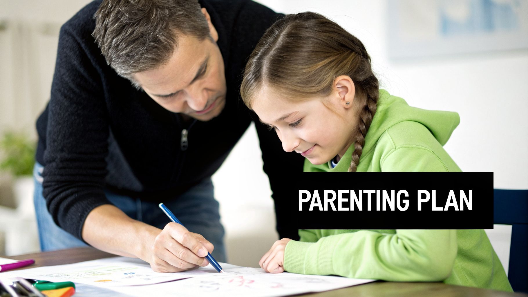 A father and daughter drawing together on a table, with the father guiding her with a pen.